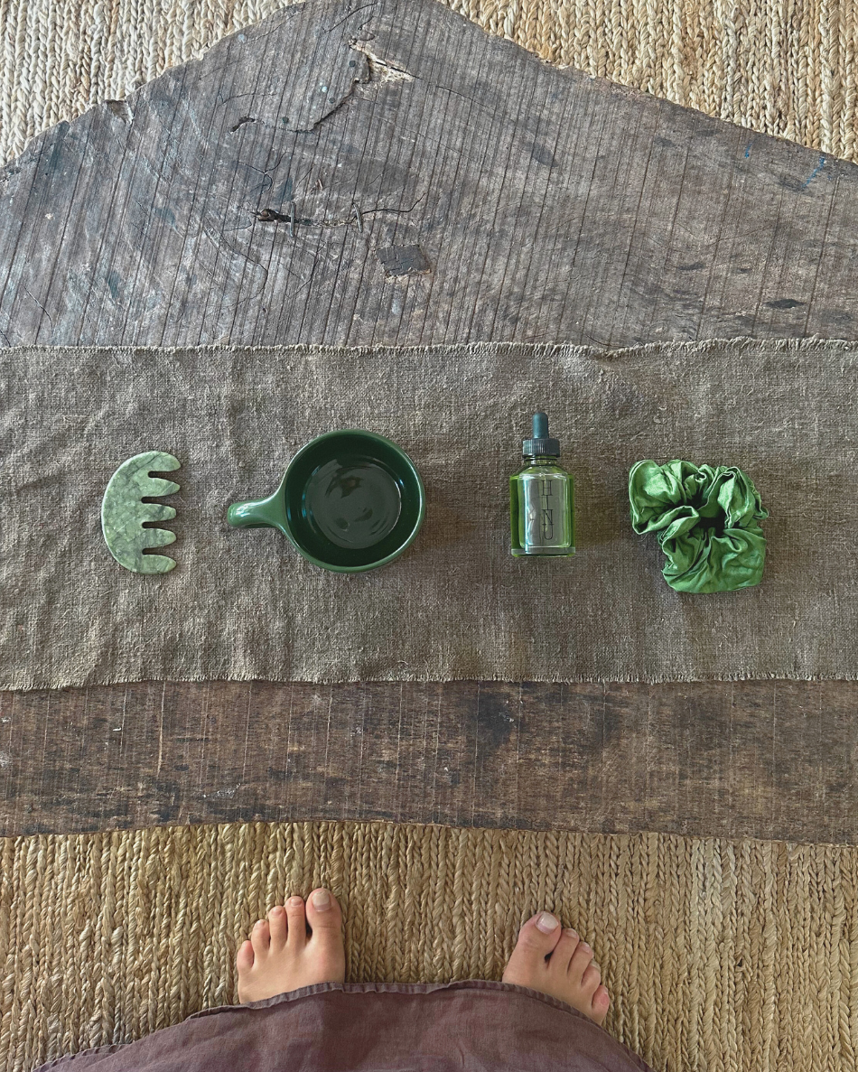 Overhead view of HINU Ritual Kit products arranged on a wooden table