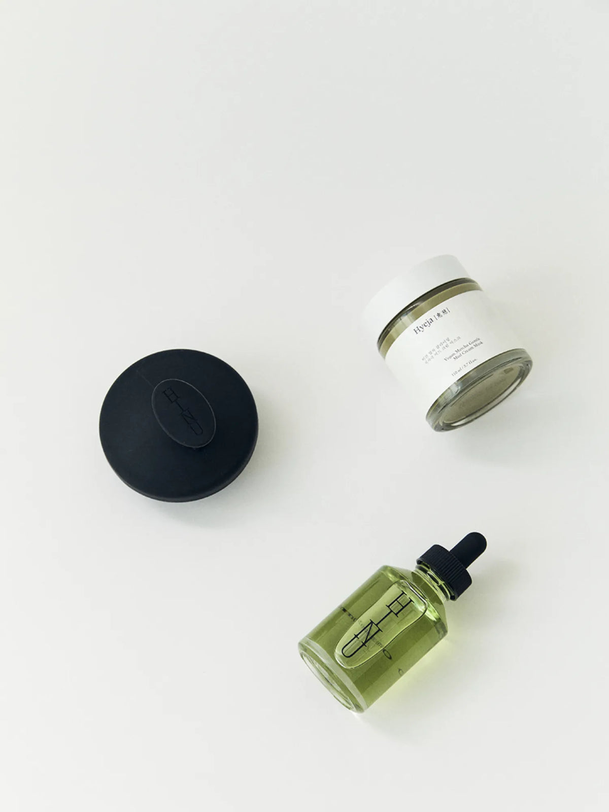 Overhead view of HINU Cleanse Kit products on an off-white background