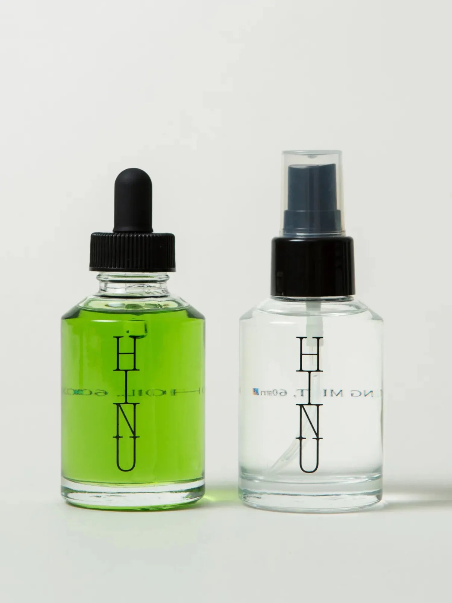 HINU Hair Growth Oil and Hydrating Mist bottles side by side