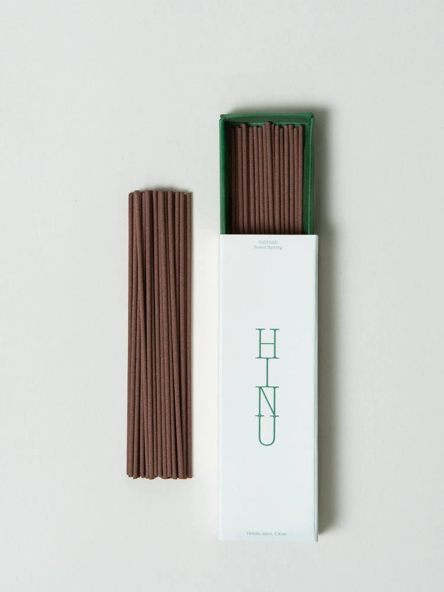 Brown HINU Forest Bathing incense sticks beside their white and green box