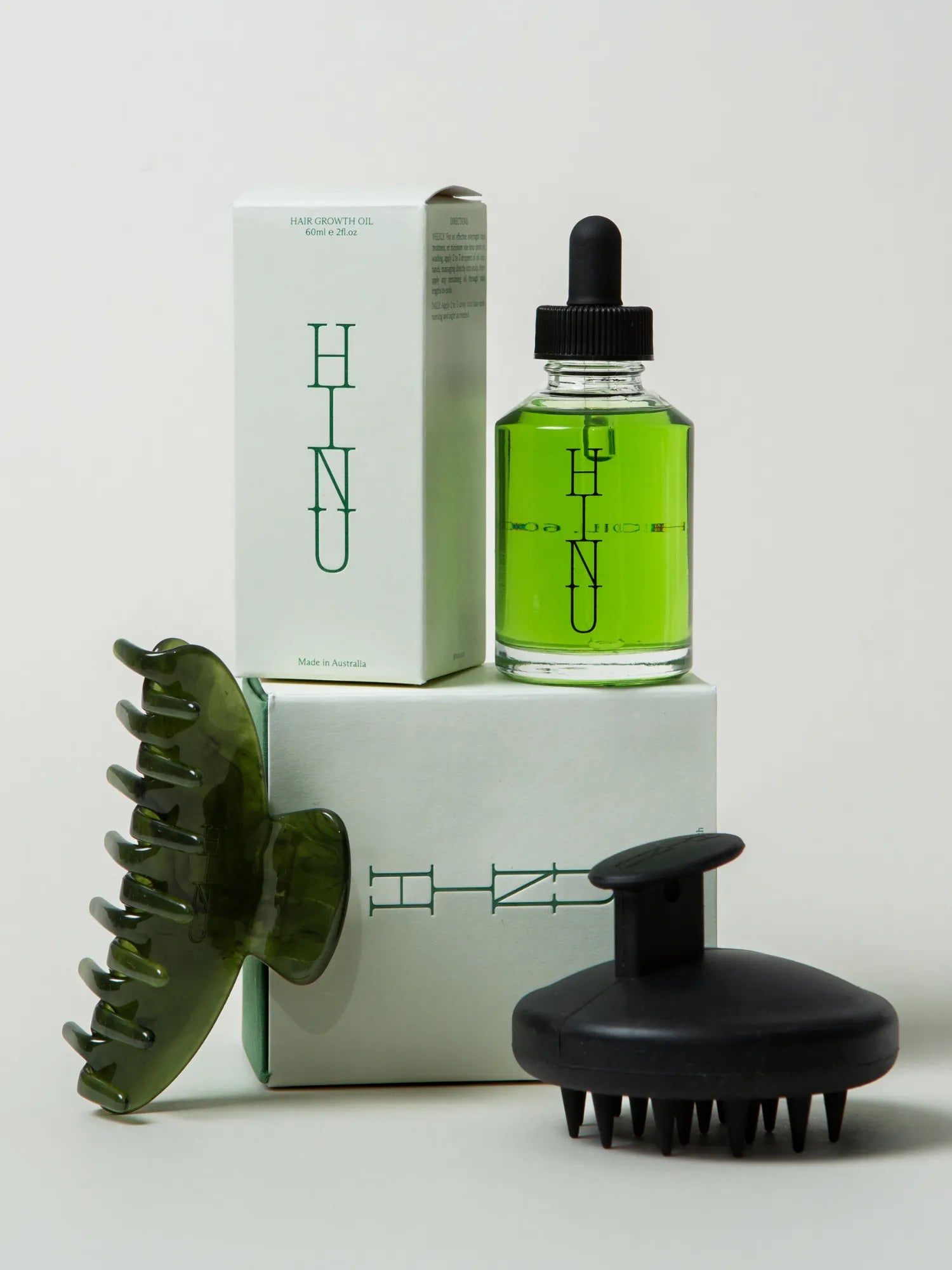 Packaged HINU Growth Ritual Set with oil, scalp massager and green claw clip
