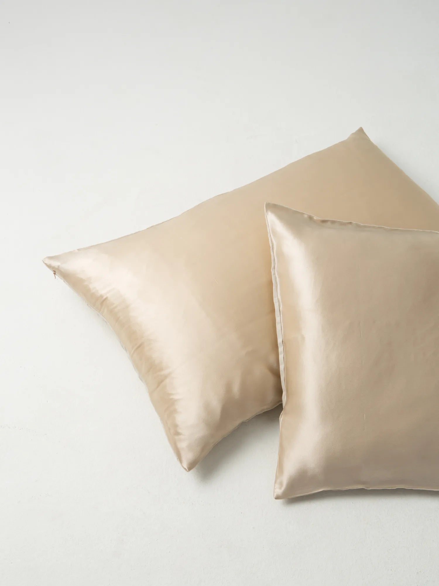 Two oat-coloured HINU Hair Protect Pillowcases arranged together