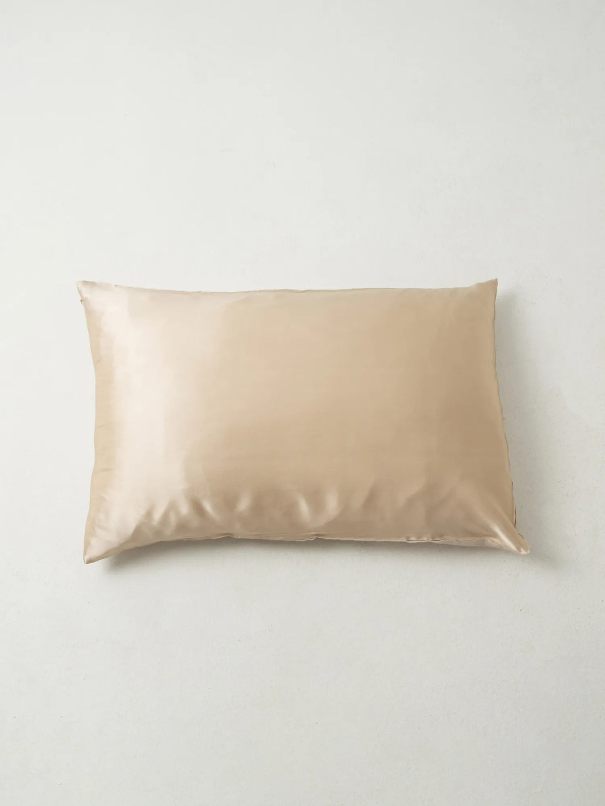 Oat-coloured HINU Hair Protect Pillowcase on an off-white background