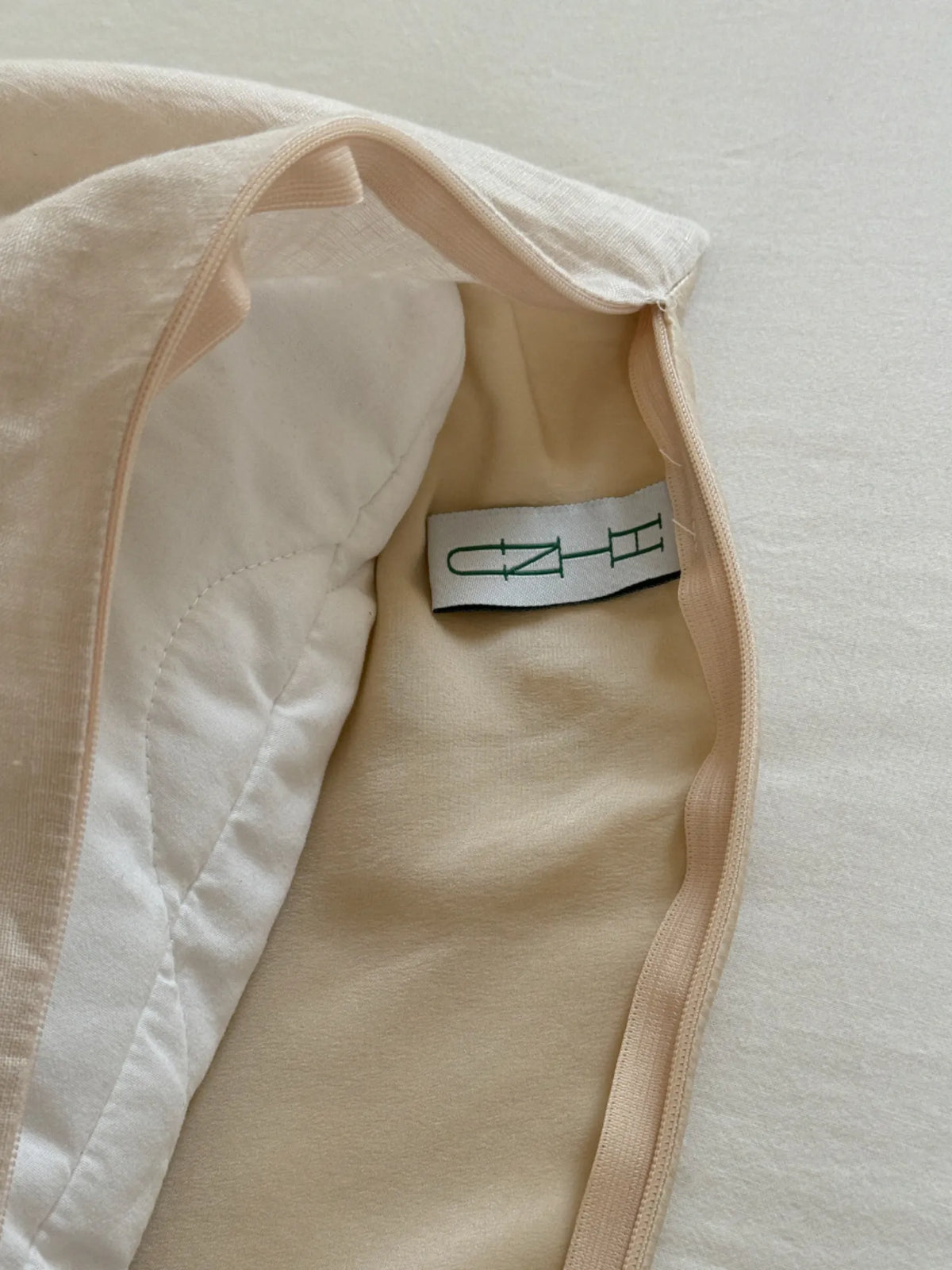 Inside view of the HINU Hair Protect Pillowcase showing its fabric layers and label