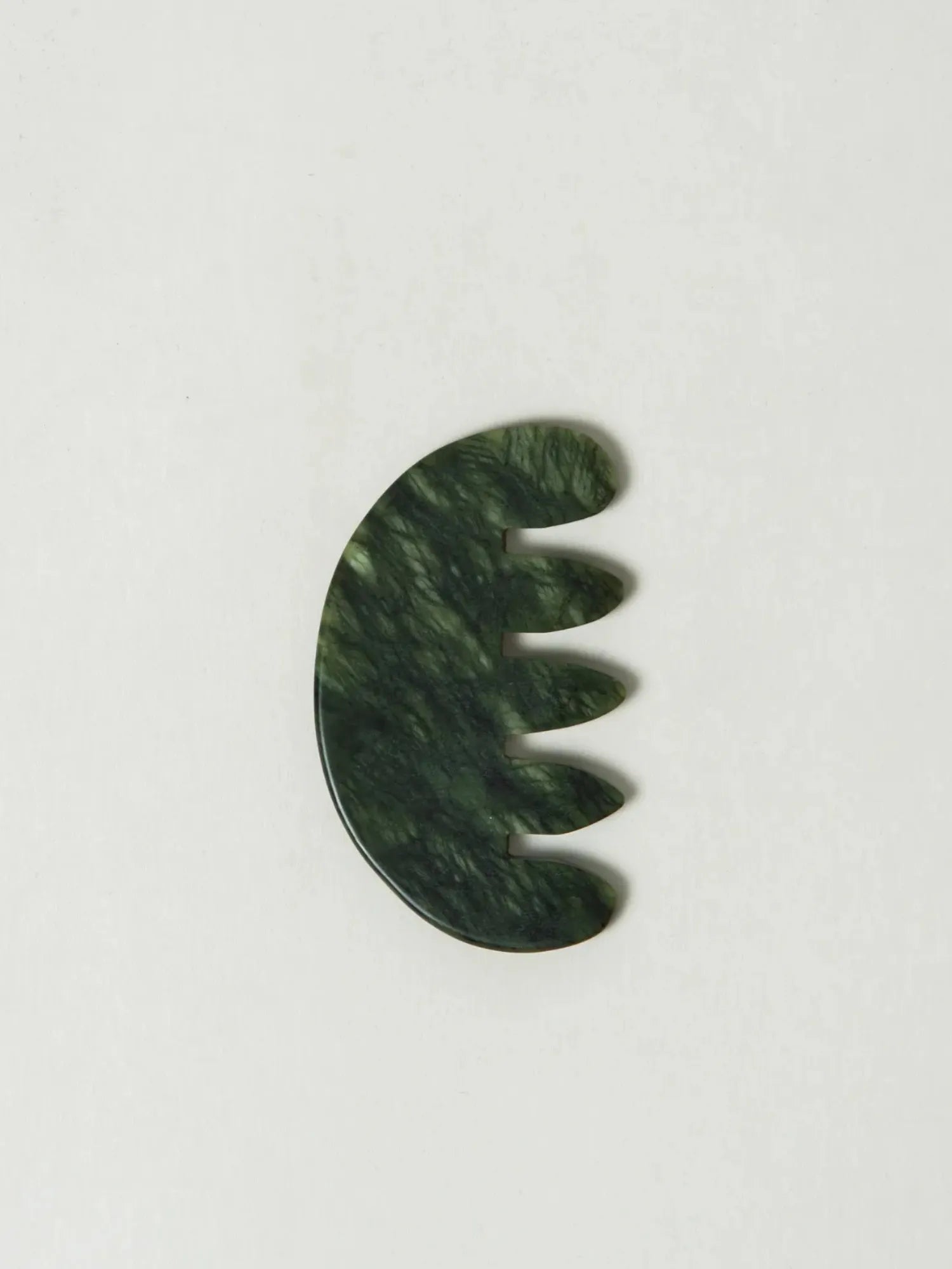 Green HINU Jade Scalp Stimulator on an off-white background