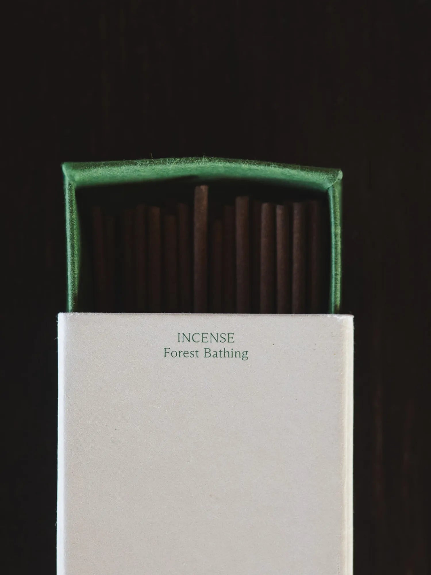 Close-up of an open HINU Forest Bathing Incense box on a dark background