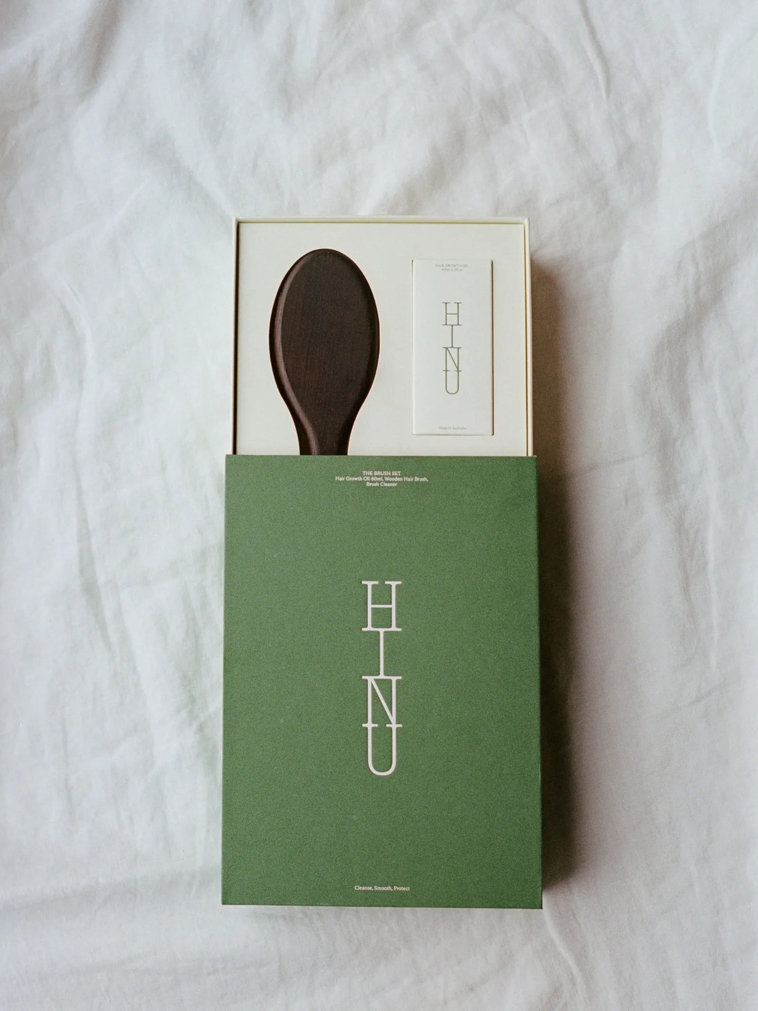 Open HINU Brush Gift Set showing the wooden brush and brush cleaner