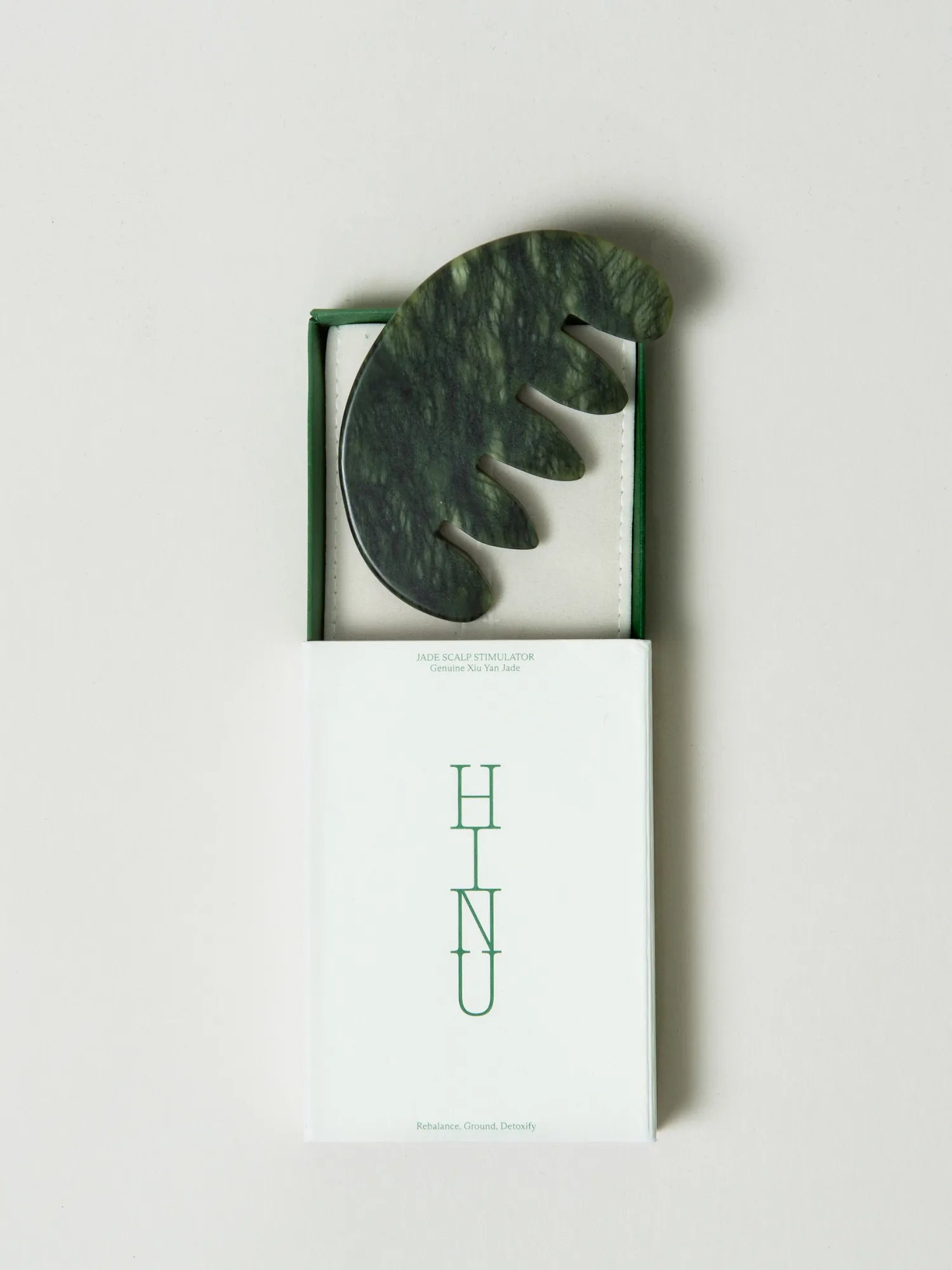 HINU Jade Scalp Stimulator displayed in its open white and green box