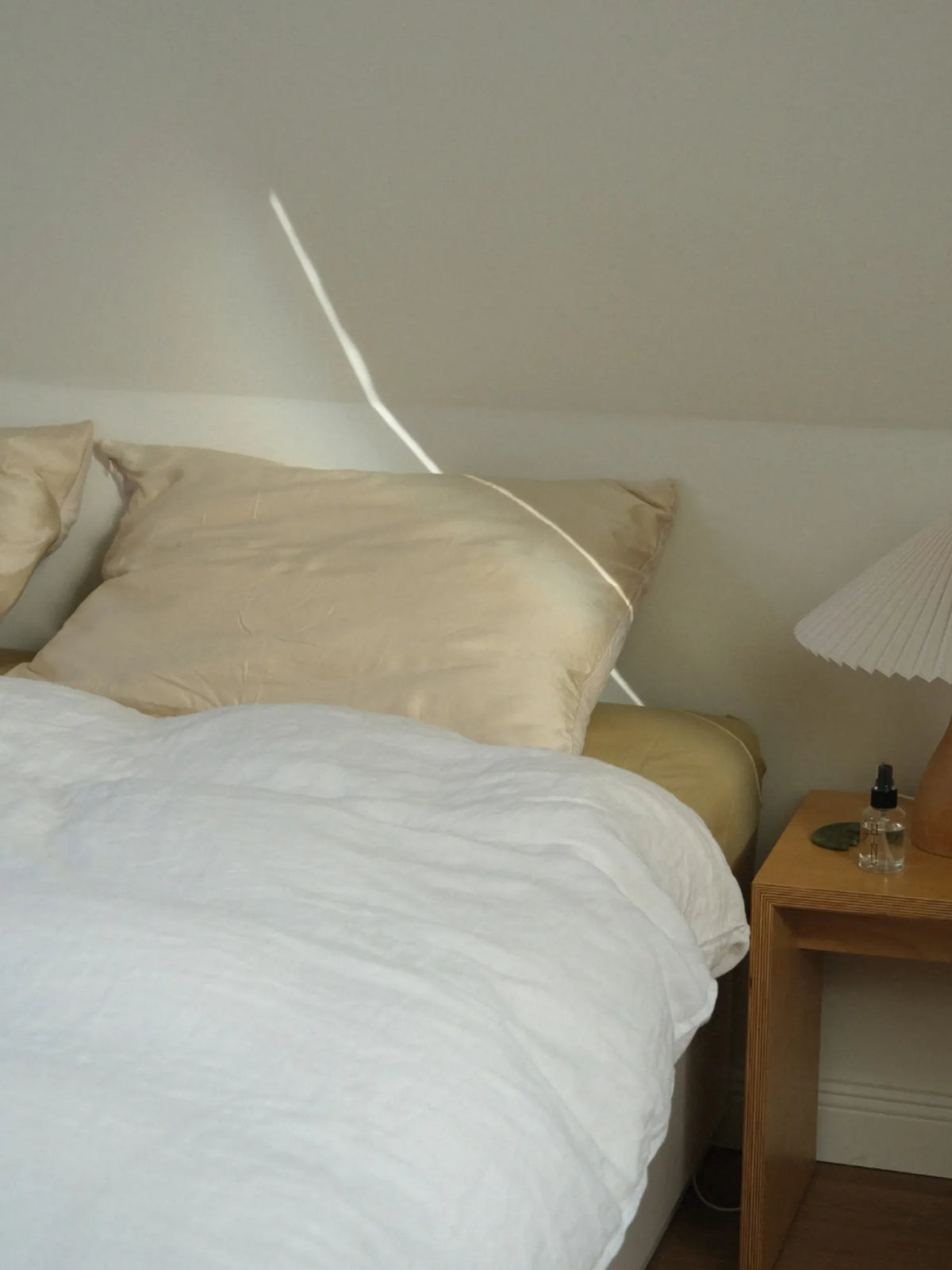 HINU Hair Protect Pillowcase styled on a sunlit bed