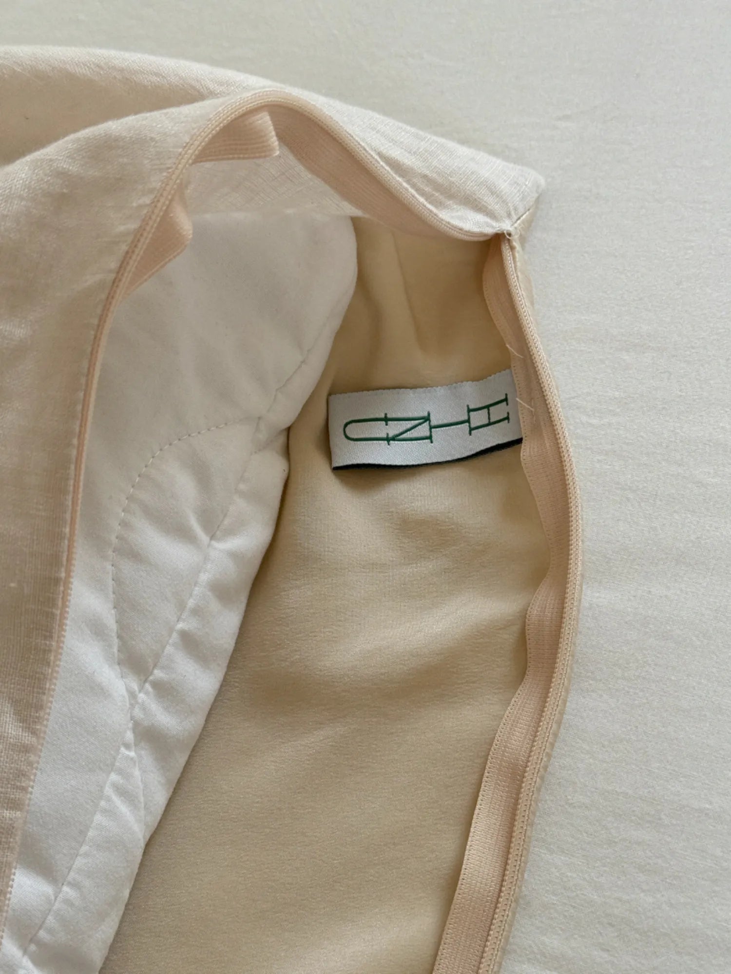 Inside view of the HINU Hair Protect Pillowcase showing its fabric layers and label