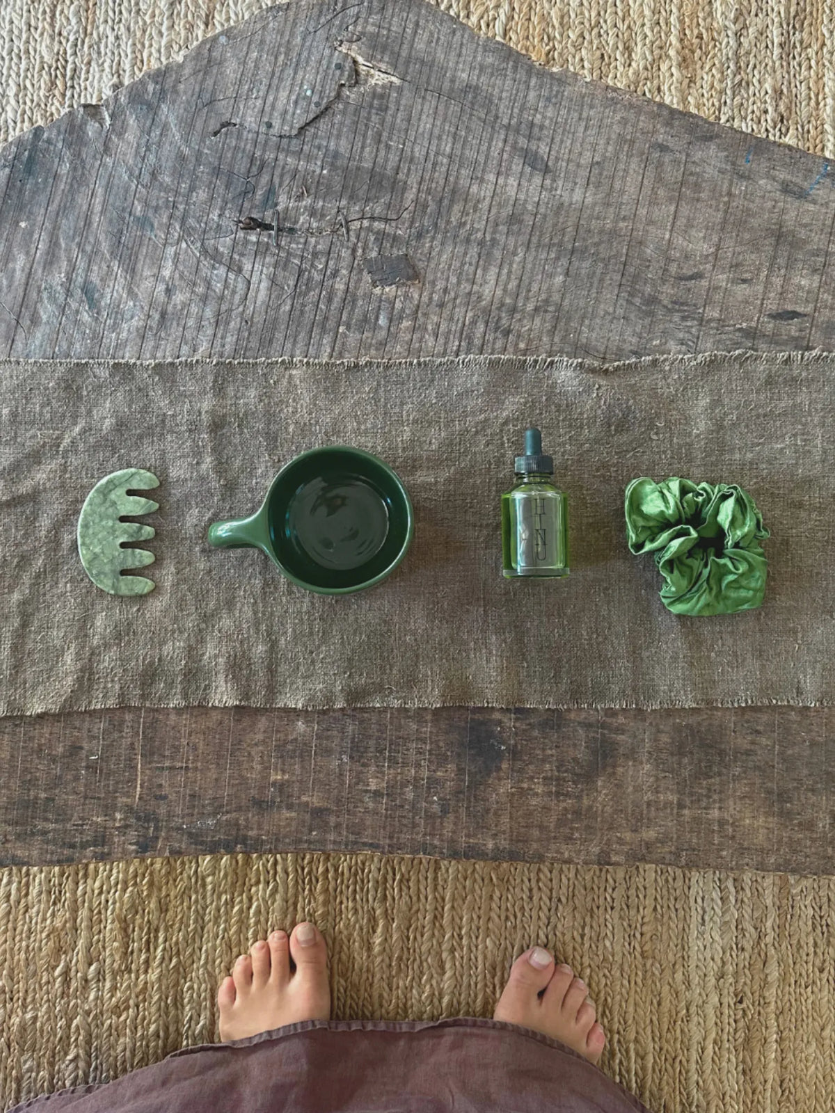 Overhead view of HINU ritual products arranged on a wooden table