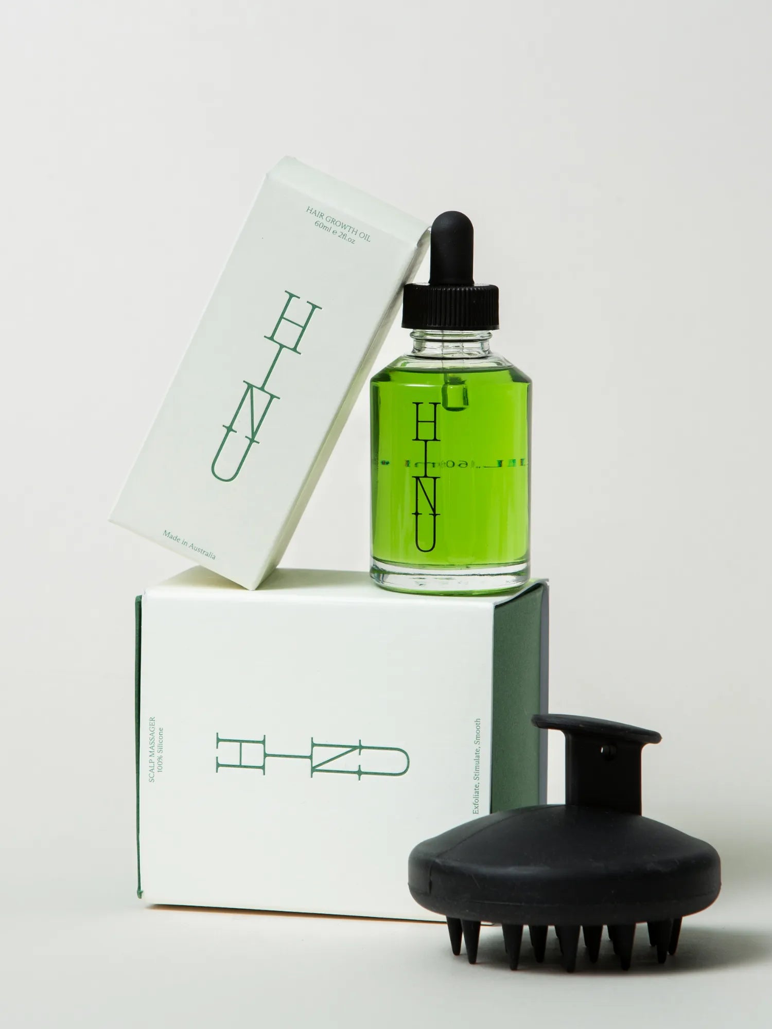 Packaged HINU Scalp Duo with Hair Growth Oil and black Scalp Massager