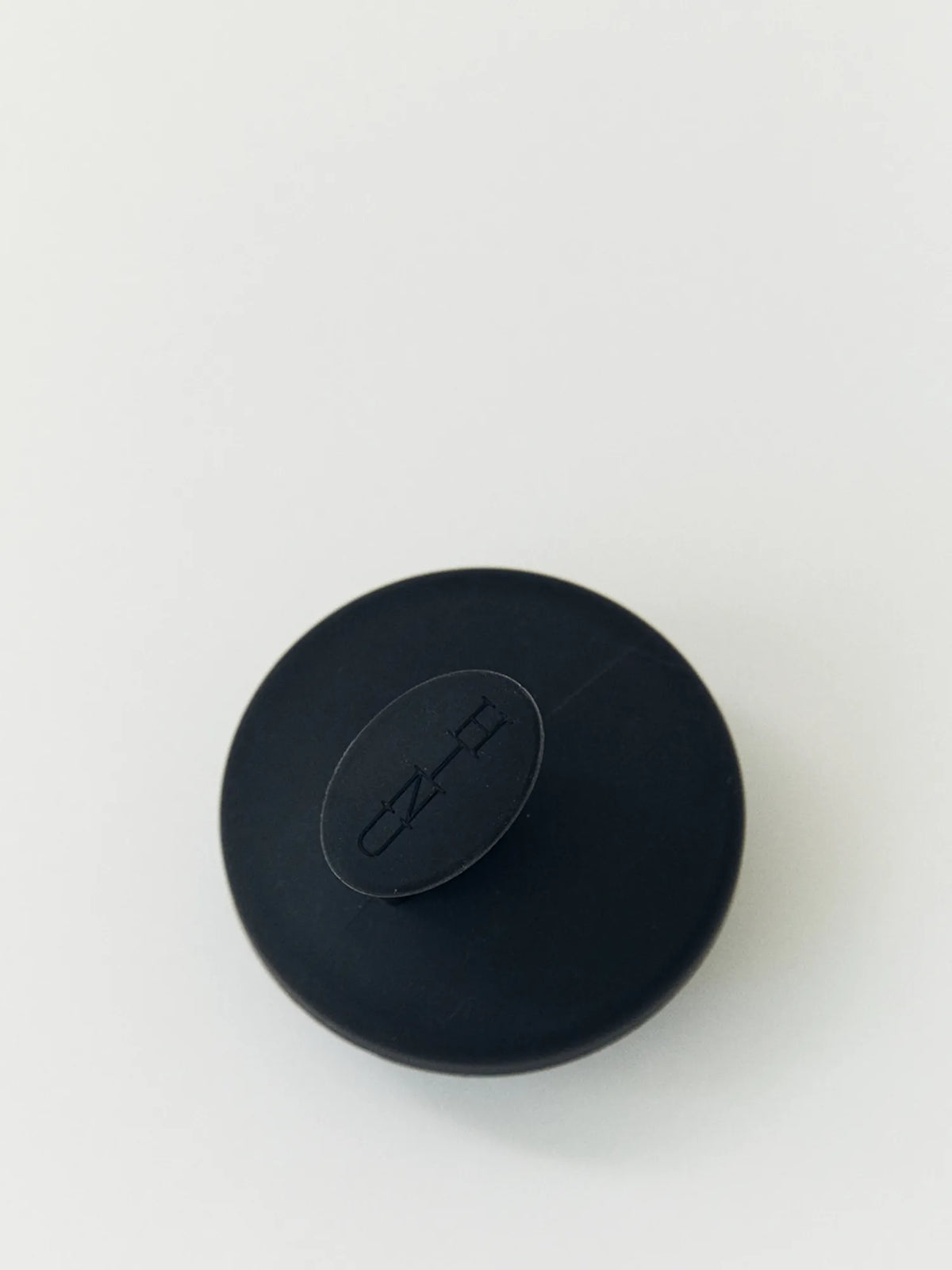 Top view of the black HINU Scalp Massager showing the HINU logo